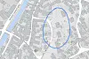 Et digitalt kart med bygninger, veier og et markert område i blått.